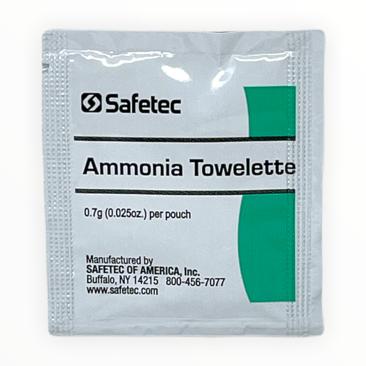 A sealed, white sachet with a green label that reads 'Ammonia Towelette', manufactured by Safetec of America, Inc.